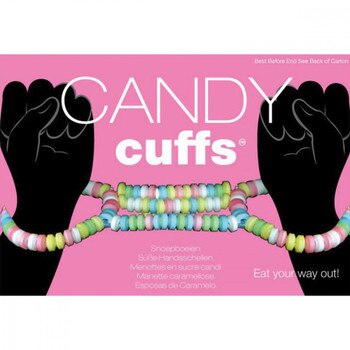 Front View of two hands with candy cuffs on their with a pink background
