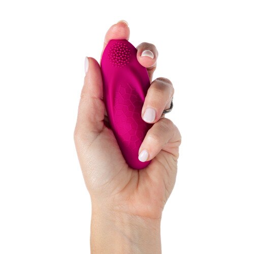 Foxy App-Controlled Wearable Panty Vibrator being held at a straight view in the palm of someone's hand on a white background