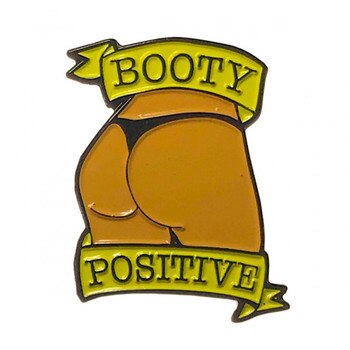 Front view of a caramel booty pin with the words Booty Positive on a white background