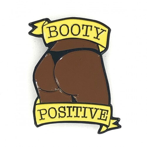 Front image of a pin with a black booty and the words Booty Positive on a white background