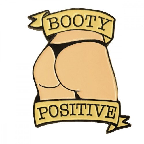 Front view of a vanilla booty pin with the words Booty Positive on a white background