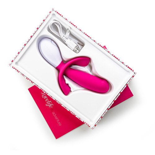 An image of Lovelife Adventure sitting in its open box with a satin privacy pouch and charging cable. The user manual lies beneath.