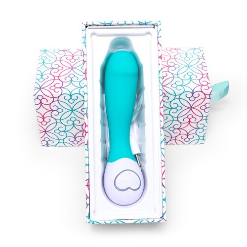 An image of the Lovelife Cuddle Mini in turquoise resting in its open packaging, the bottom part of the box propped up against the lid. The box is white with turquoise, pink and purple patterning.
