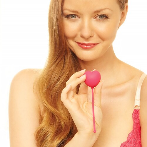 An image of a blond woman smiling at the viewer holding up one on of the Lovelife Flex weights in her hand in front of her.