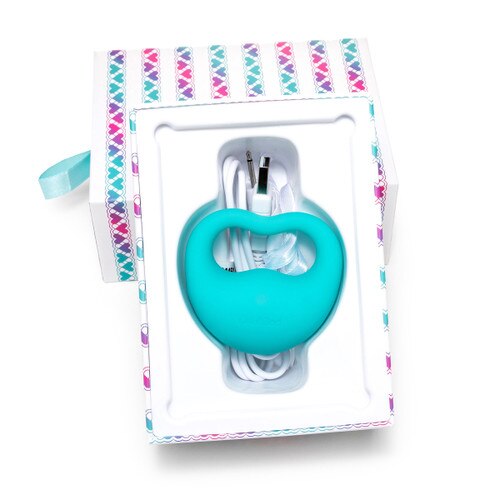 An image of Lovelife Rev sitting in its packaging. It rests in a tray with a satin privacy pouch and charging cable, the bottom of the box propped up against the colorfully patterned lid.