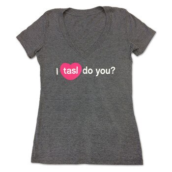 A dark gray V-neck t-shirt with the words "I tasl do you?" in white lettering with tasl inside a pink heart, recreating the icon for the tasl app.