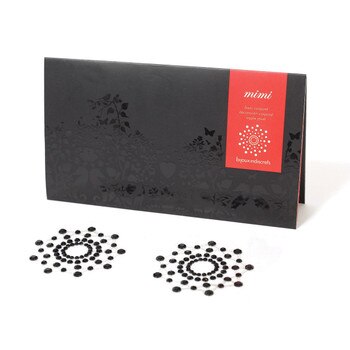 An image of a pair of black rhinestone pasties arranged in a starburst shape next to their black and red packaging.