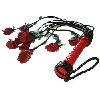 A red-handled leather flogger whose tails are tipped with leather dyed and folded to look like a bouquet of roses.