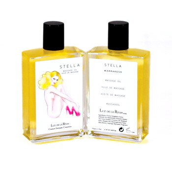 A clear bottle with a black cap of golden-colored Stella Massage Oil in Marrakesh, viewed front and back.