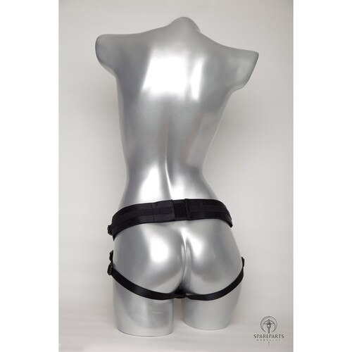 A rear view of a silver mannequin wearing the black joque harness, demonstrating where the straps sit on the hips and under the buttocks.