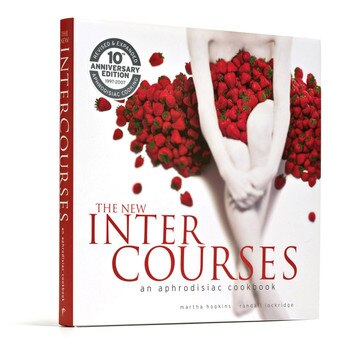 An image of the cover of The New Intercourses aphrodisiac cookbook. The cover art features a sensual photo of a pale woman covered in a pile of strawberries.