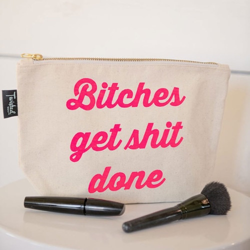 Bitches Get Shit Done Travel Make Up Vibe Bag with make up brushes around it on a counter top